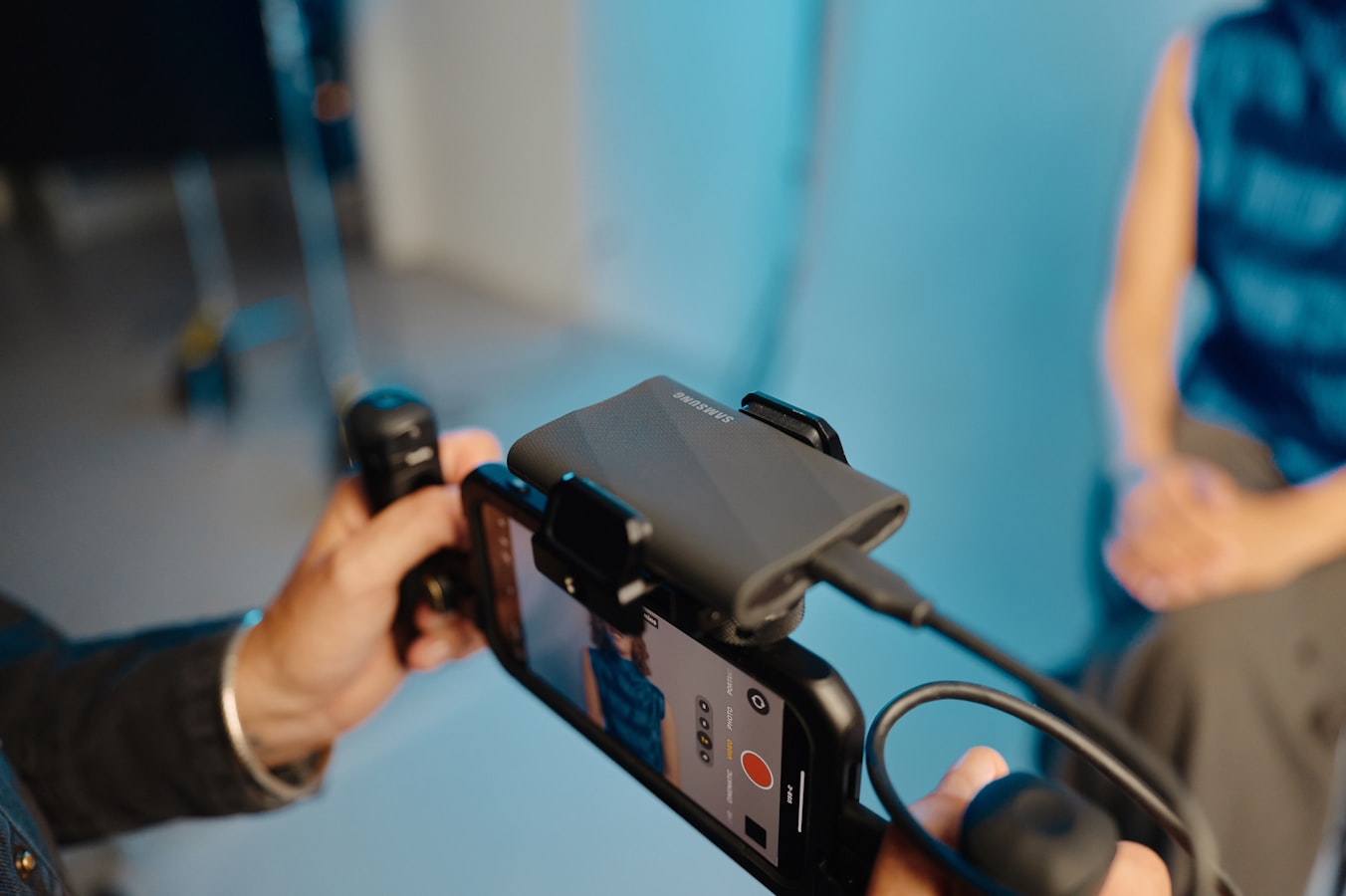 A professional sharing their digital business card from a smartphone with a colleague