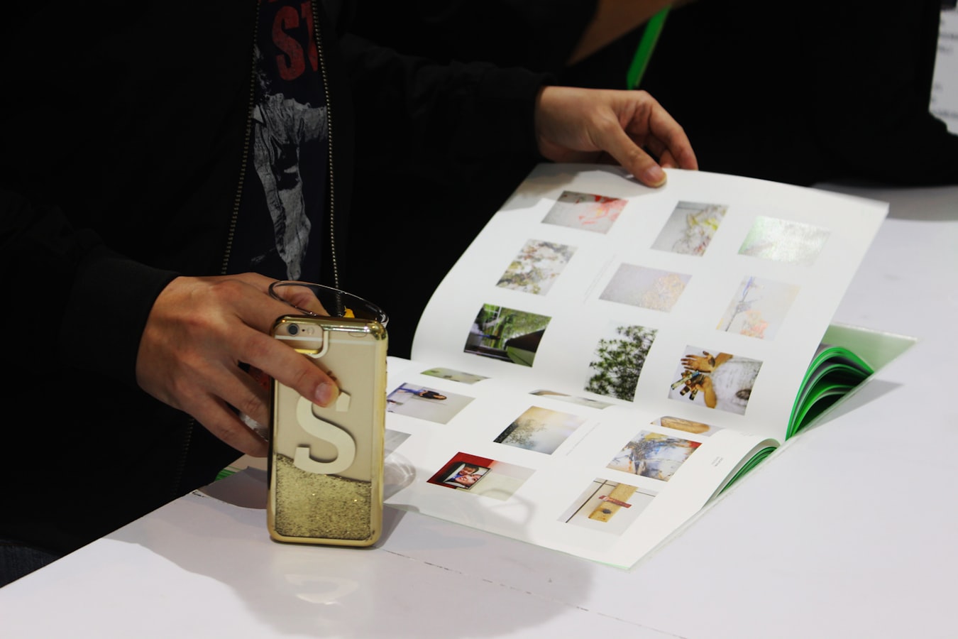 A customer reviewing a printed proof at a print shop counter