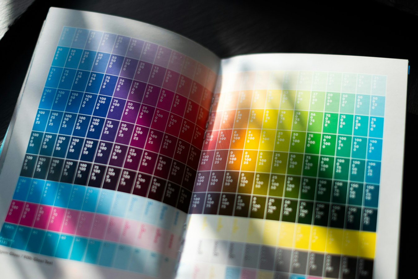 Close-up of a commercial printing press laying down dense black ink on paper