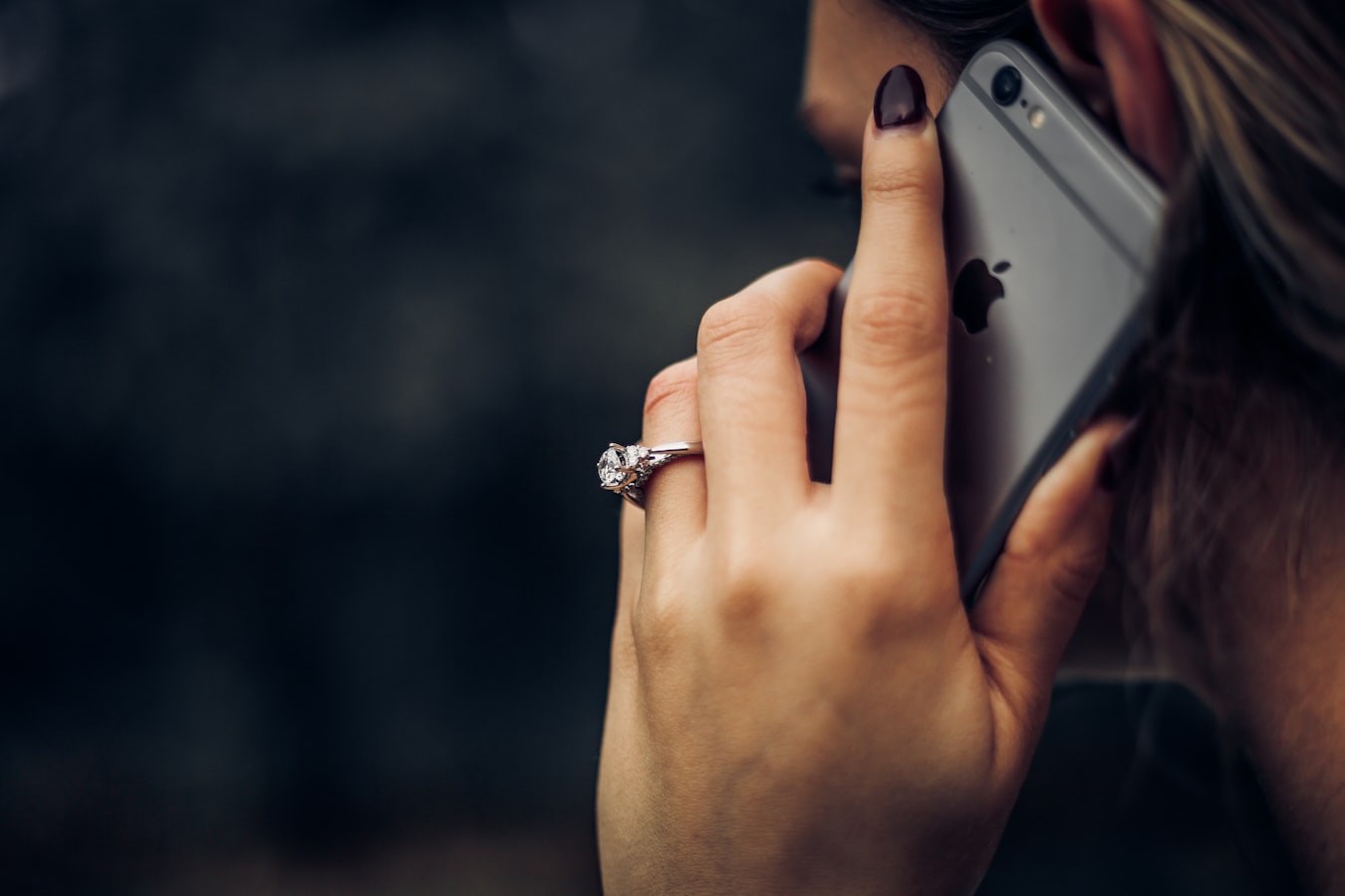 A person tapping their smartphone to share contact details with someone nearby