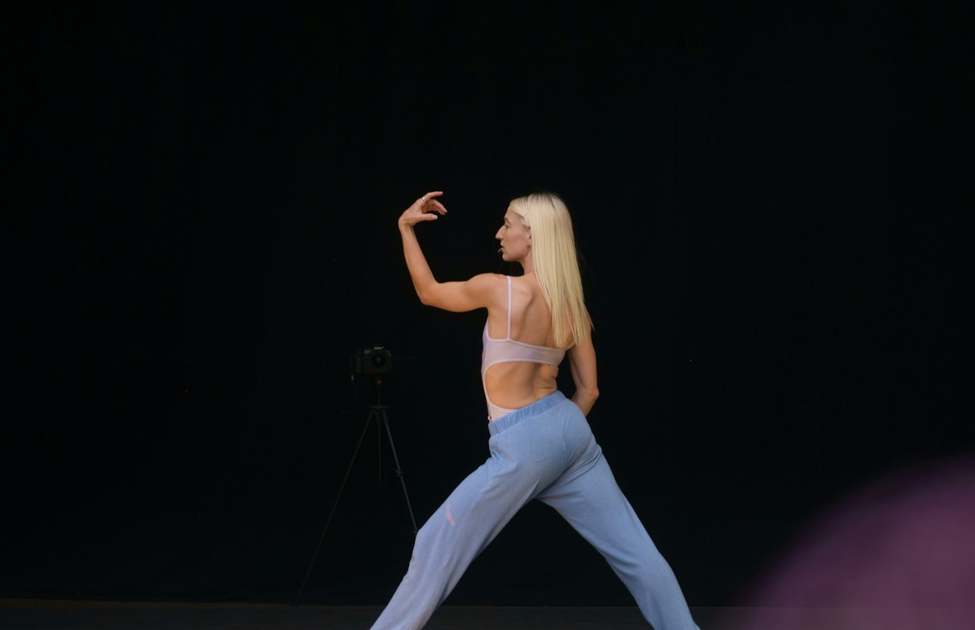 Photographer capturing athletes on stage at a fitness competition