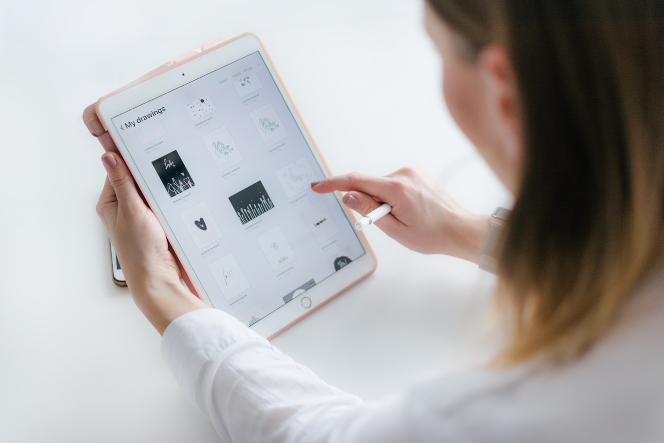 A short-term rental host reviewing guest documentation on a tablet at a kitchen counter