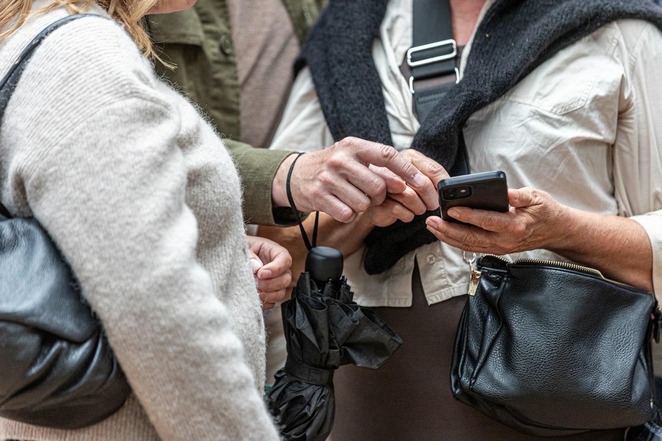 Two professionals sharing contact information by tapping their phones together