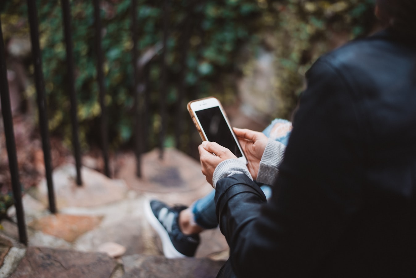 Two professionals greeting each other and sharing contact details on a smartphone