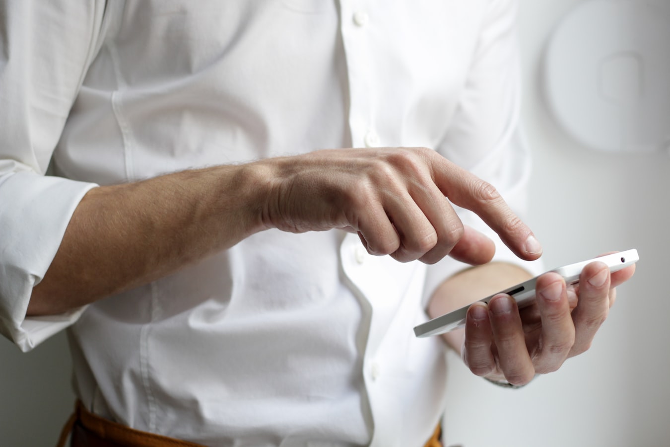 A person saving a contact on their smartphone