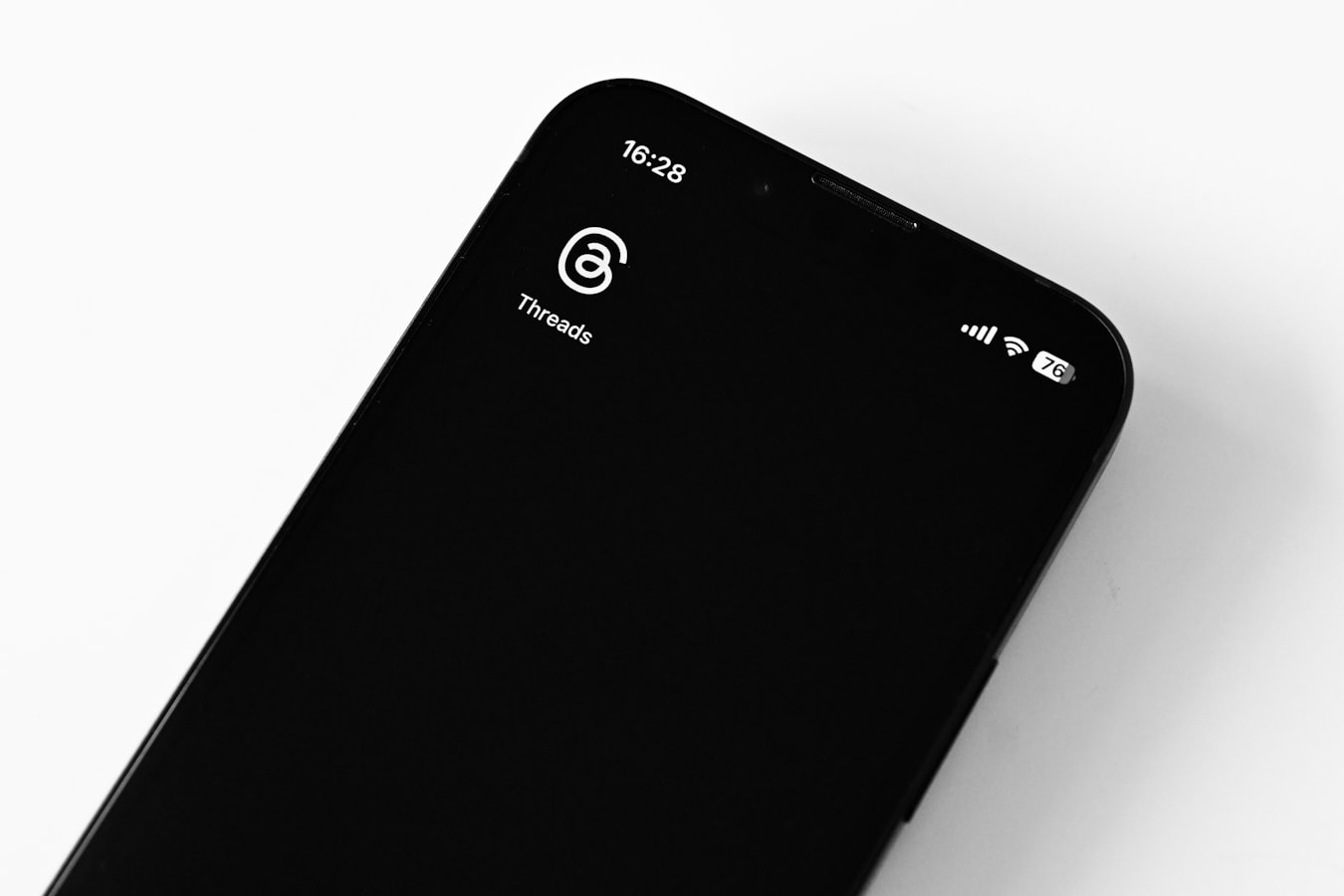 A person tapping their phone to share contact details with someone else in a professional setting