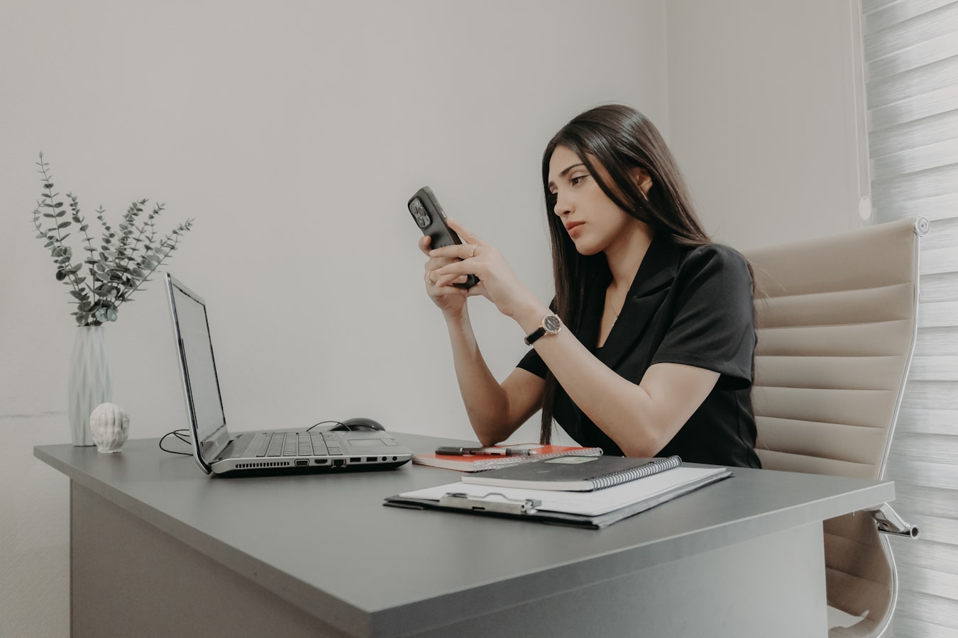 A professional looking at their digital business card on a smartphone screen