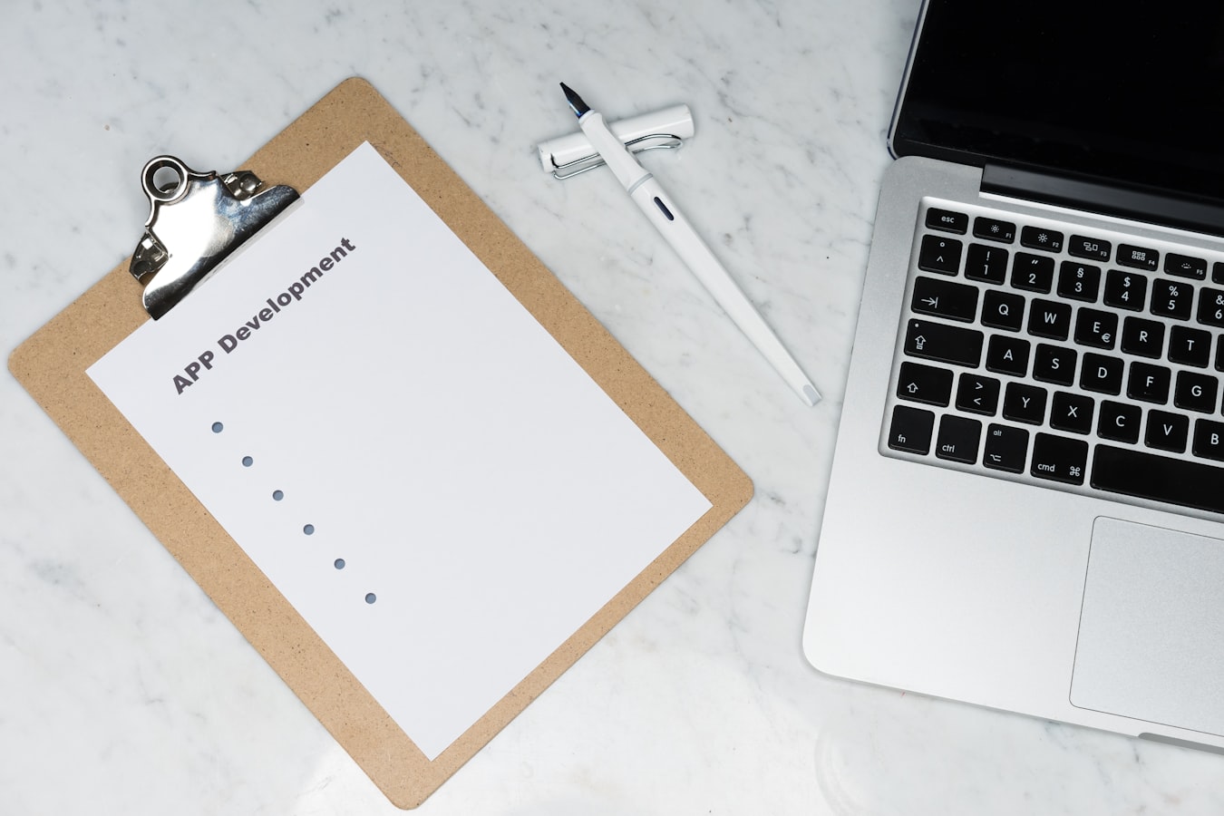 A clipboard with a checklist resting on a wooden table in a tidy short-term rental