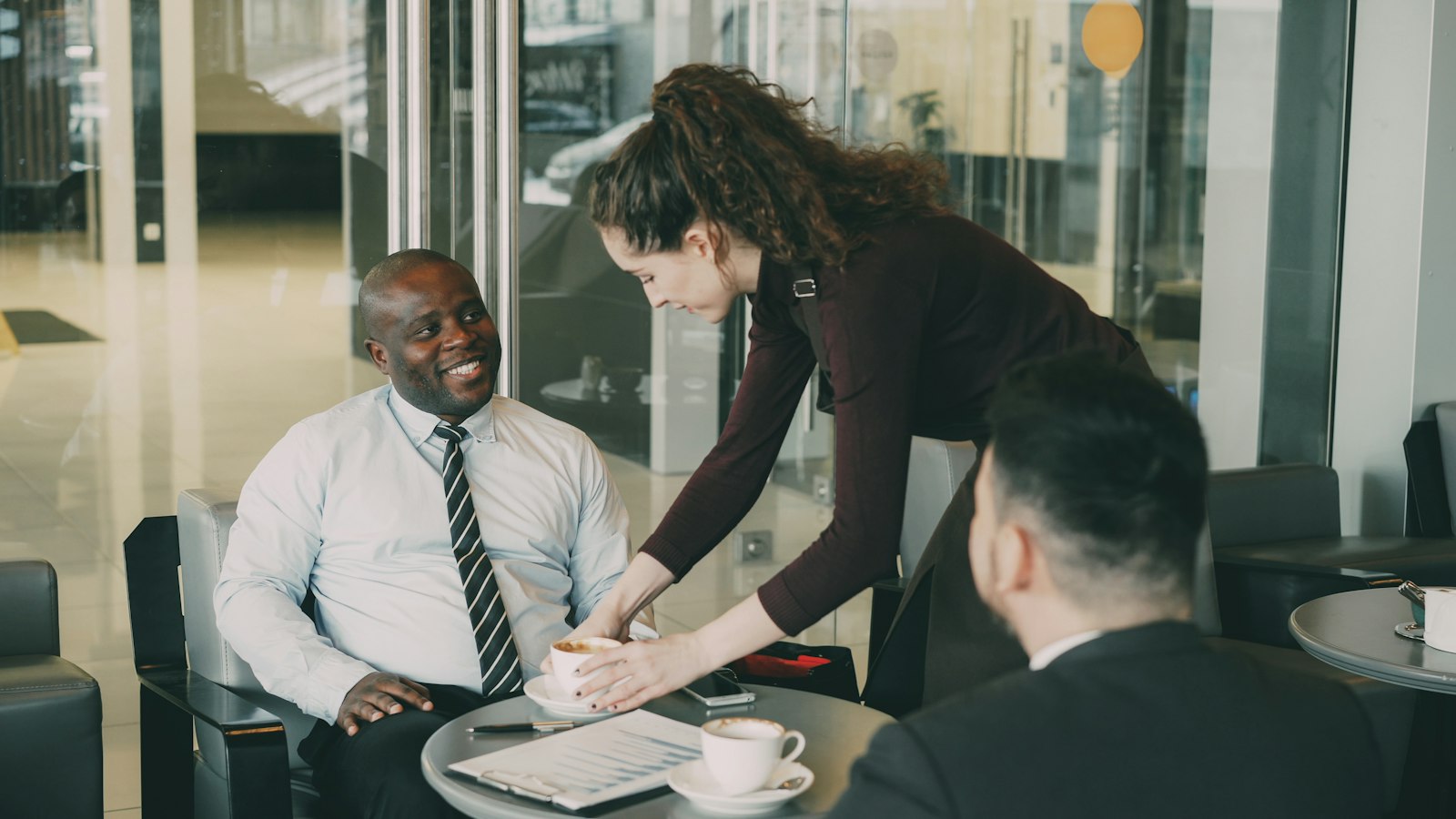 A therapist sitting across from a client in a warm, welcoming office setting