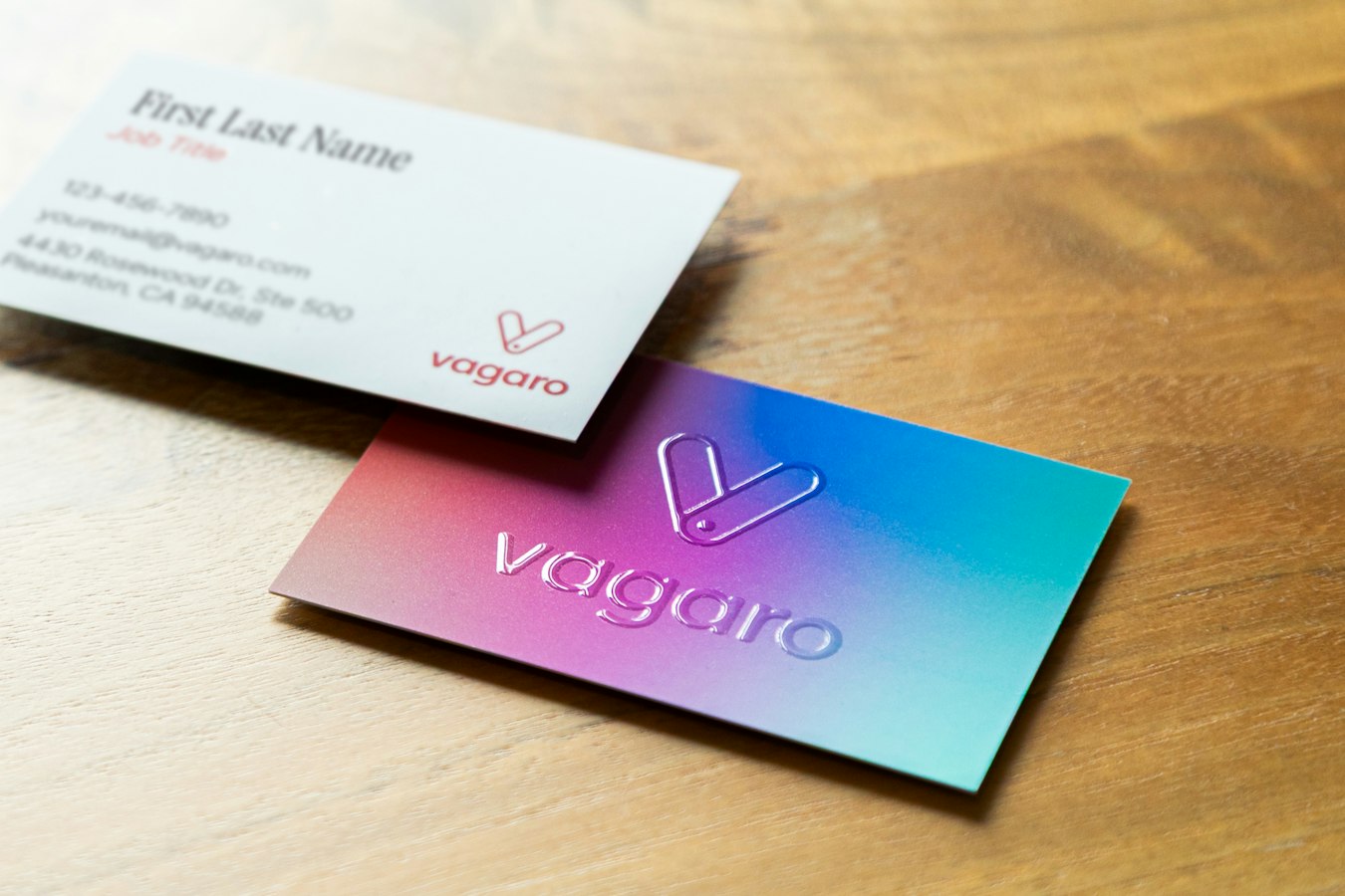 Stack of printed business cards coming off a commercial printing press