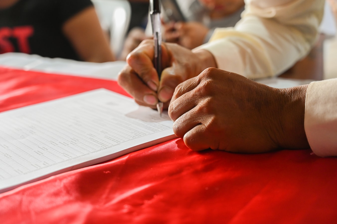 Photographer reviewing a bilingual Spanish-English model release form with a subject on set