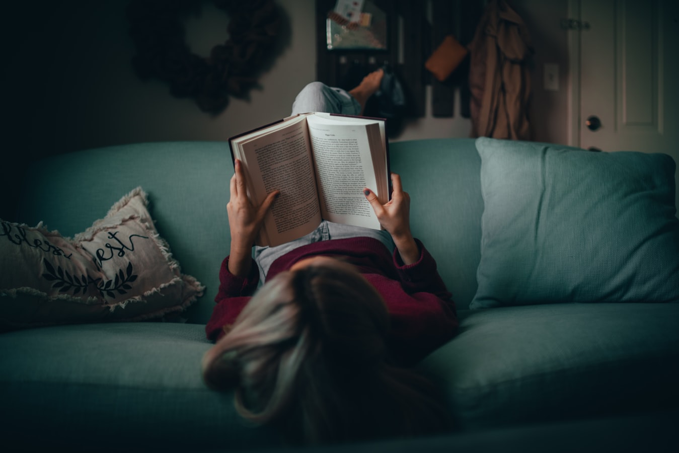 A guest reads a printed house rules booklet at a short-term rental property