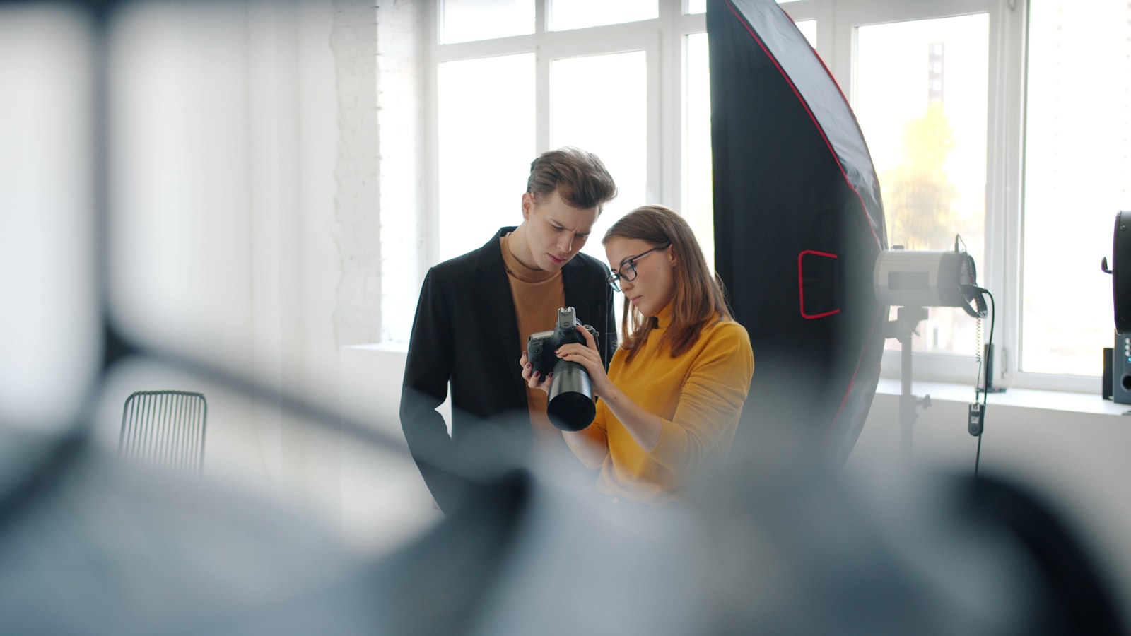 Photographer and model reviewing a printed release form before a studio shoot