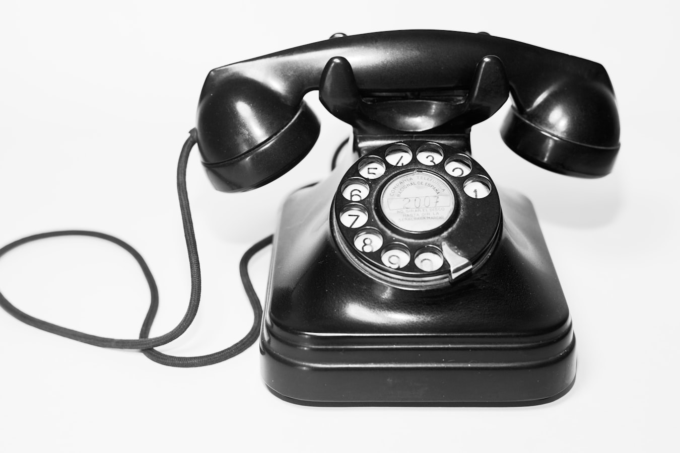 A professional sharing their contact details on a smartphone with a colleague