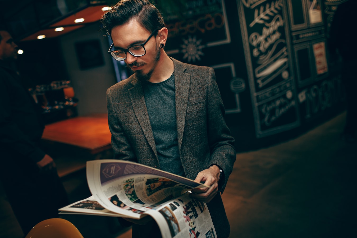 Small business owner reviewing a printed flyer at a shop counter