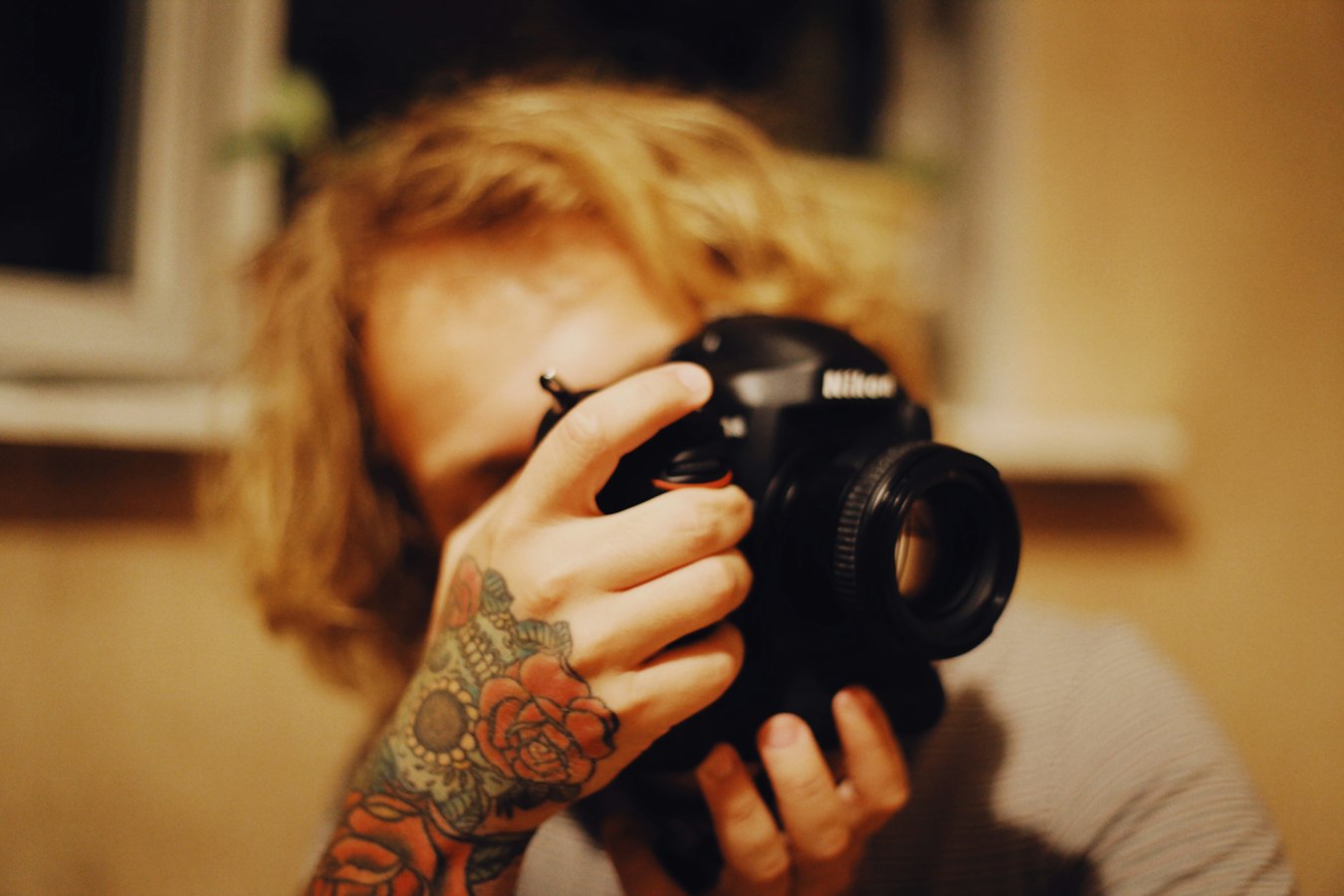 Photographer reviewing a model release form with a tattooed subject before a shoot