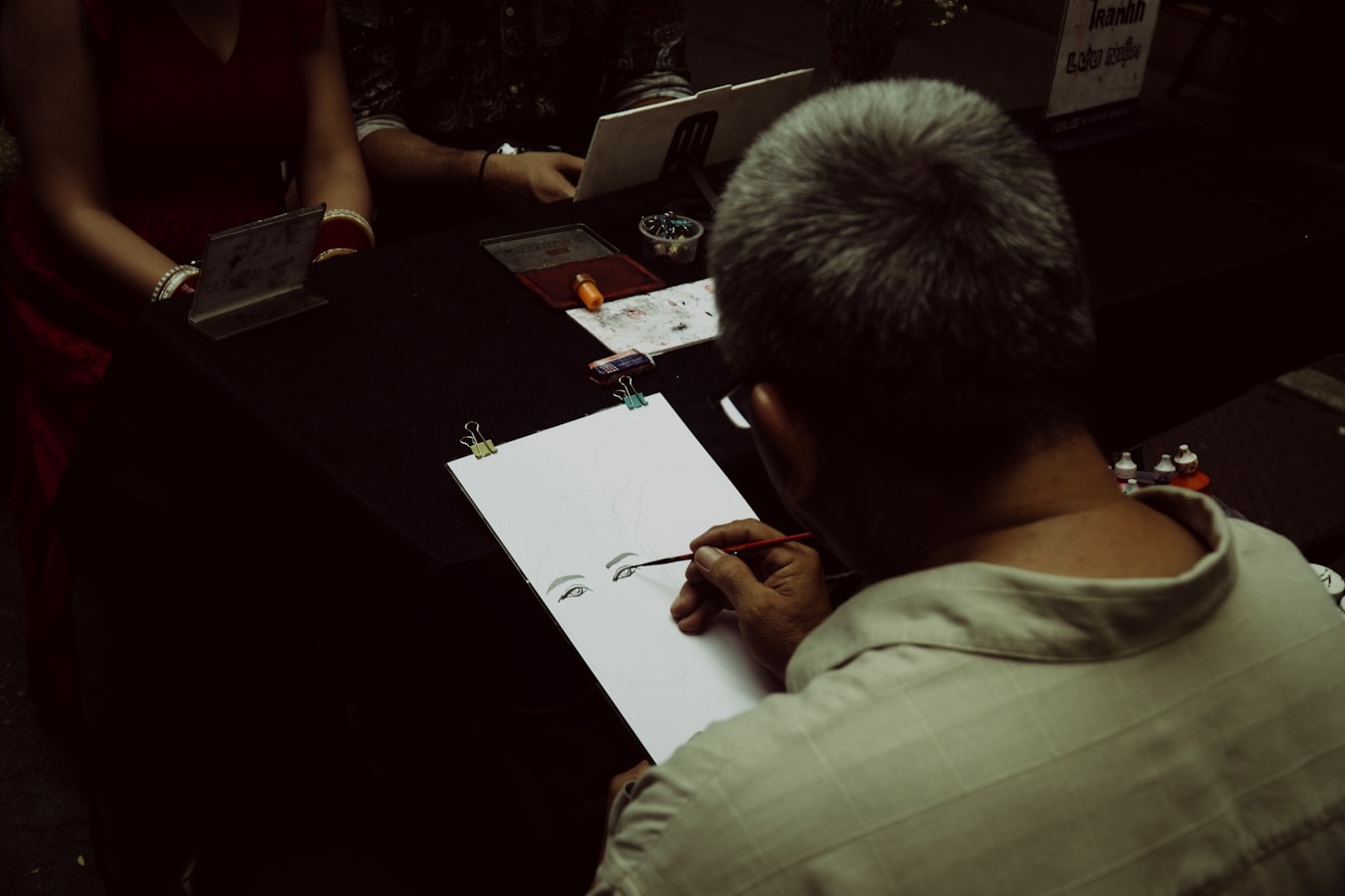 Photographer reviewing a signed release form with a model on set