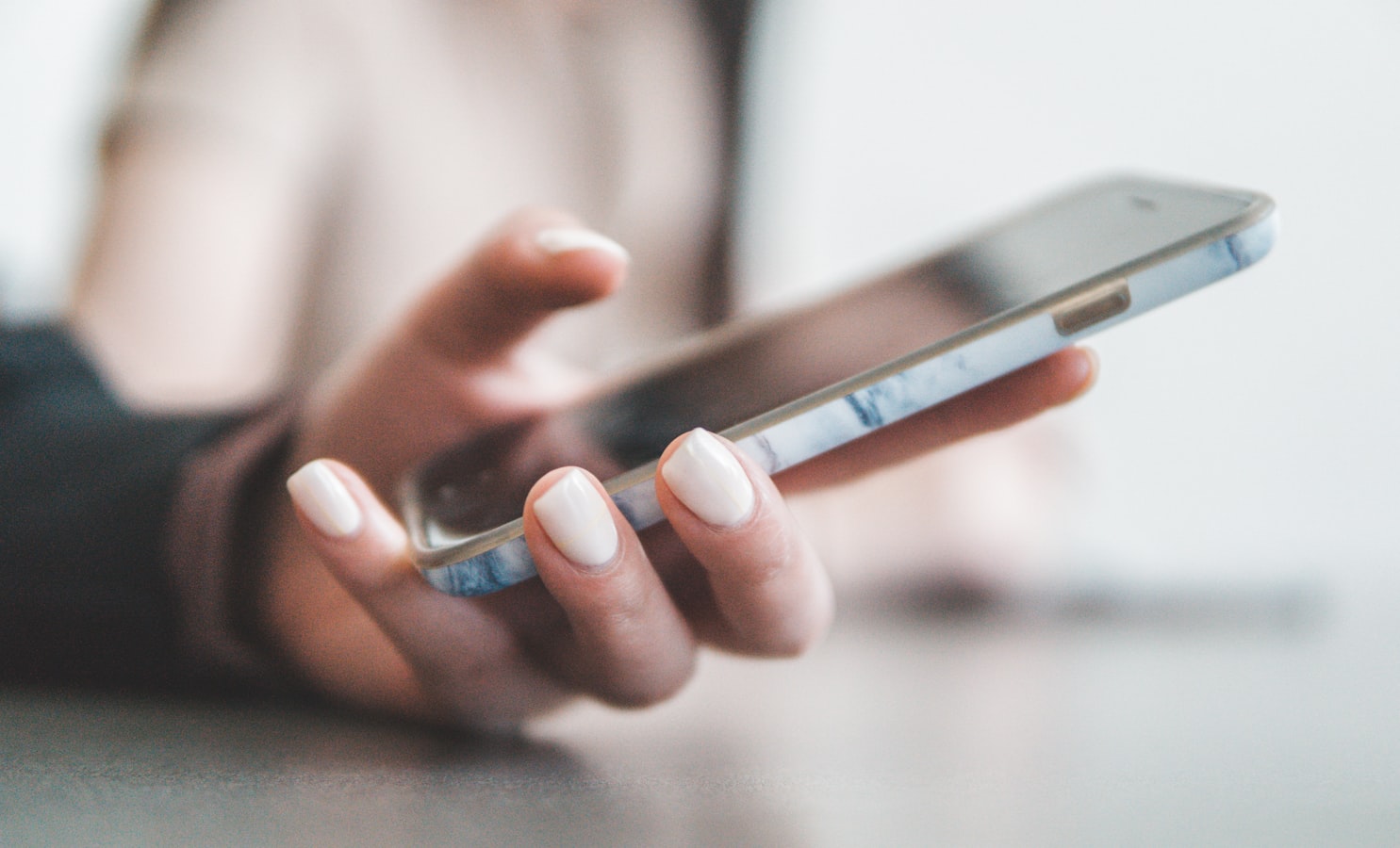 A person holding an Android phone, ready to share contact information