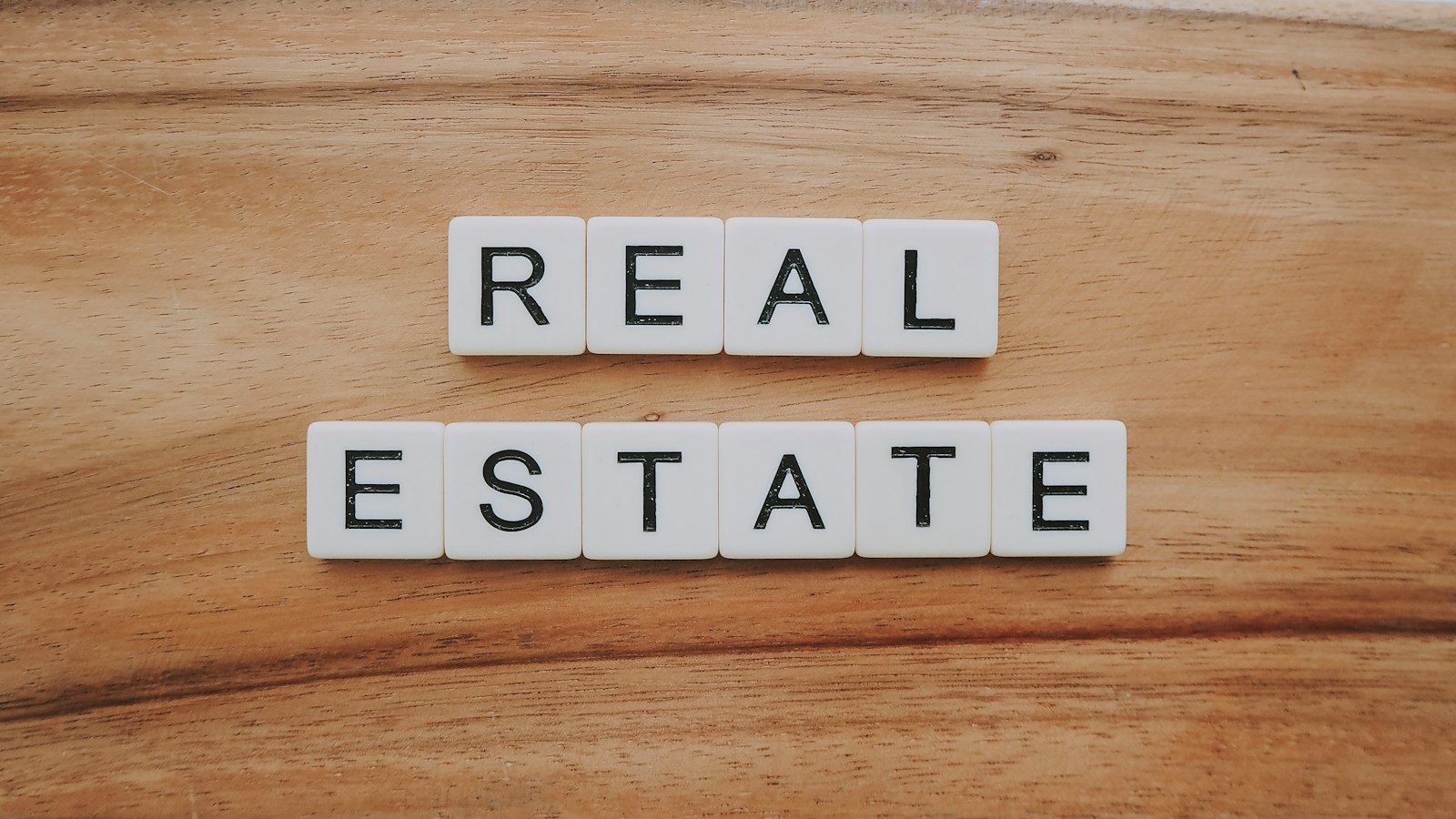 A small real estate team gathered around a table reviewing property details together