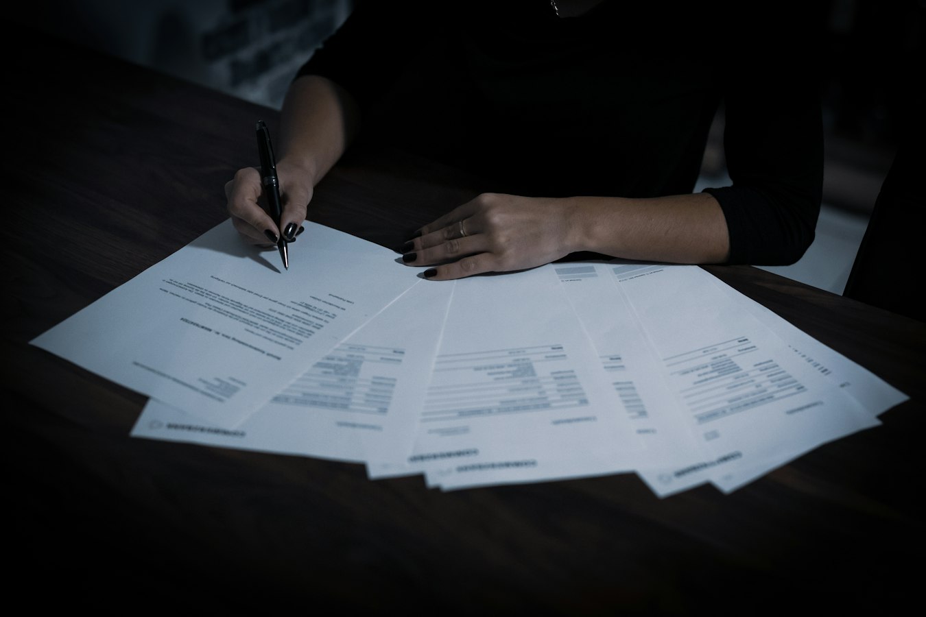 A host reviewing a printed vacation rental agreement on a desk beside a set of house keys