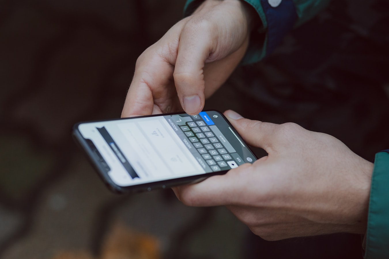 A professional updating their contact details on a smartphone