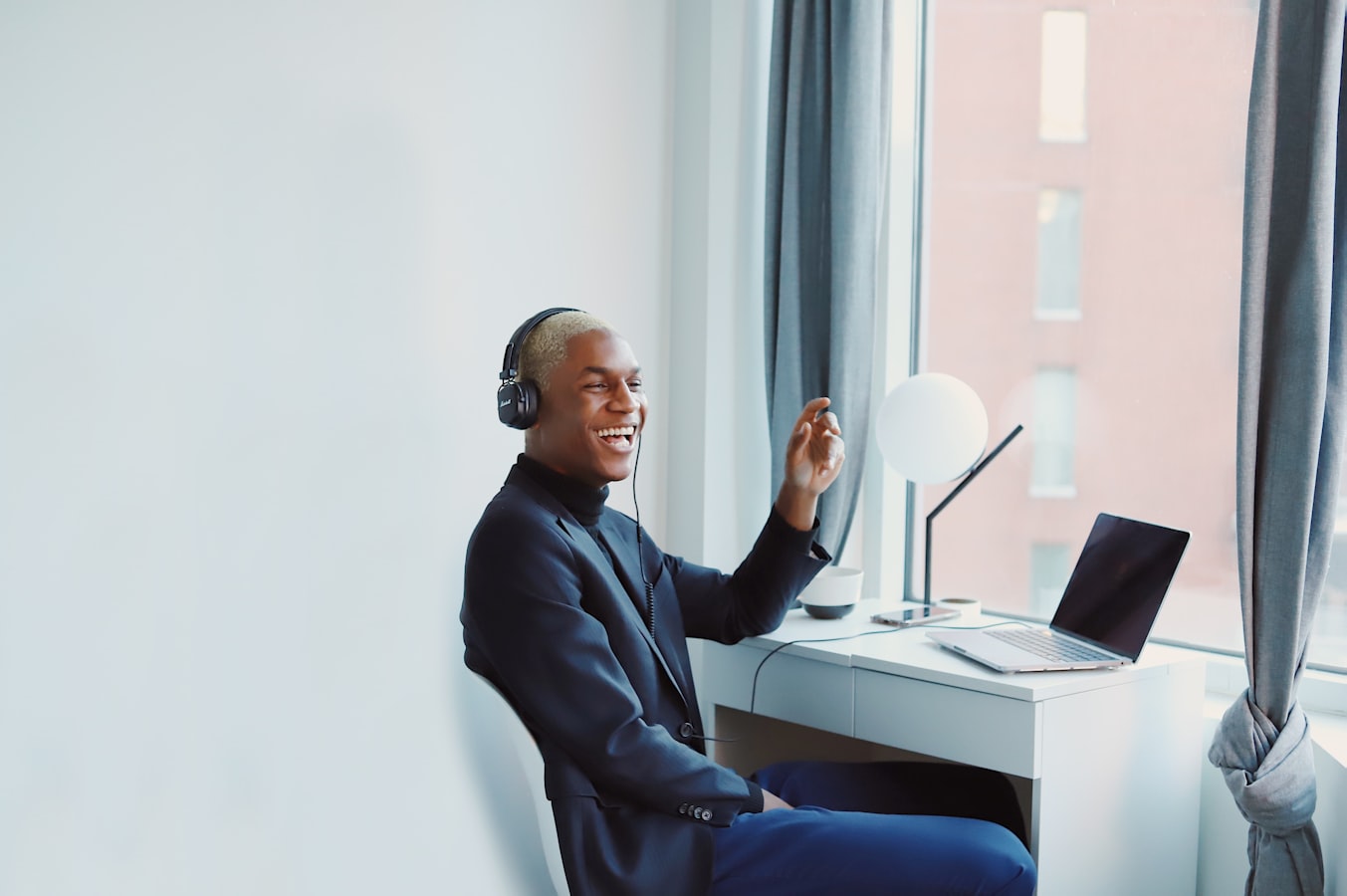 A remote worker on a video call at a tidy home office desk