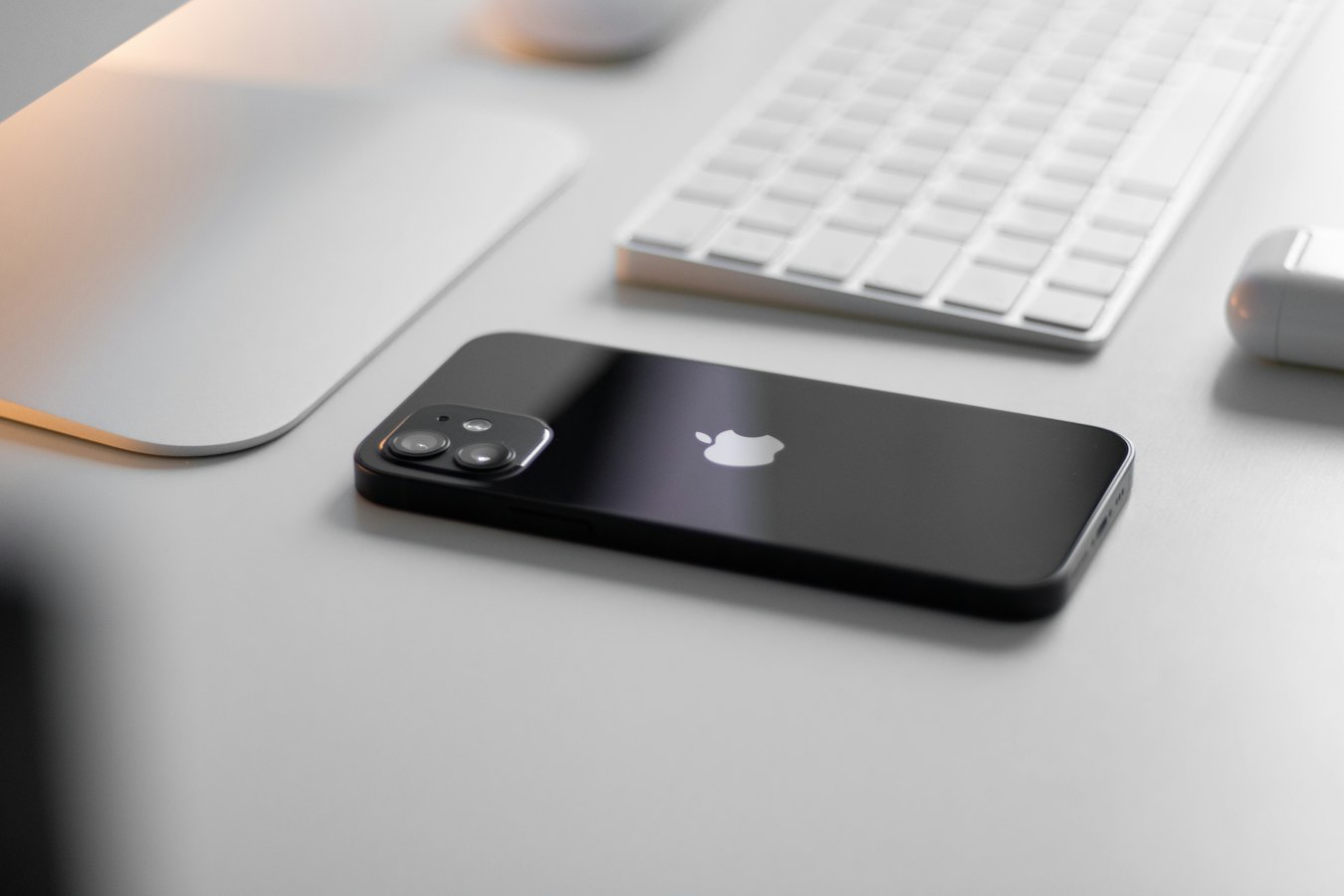 A person composing an email on an iPhone with a professional email signature visible on screen