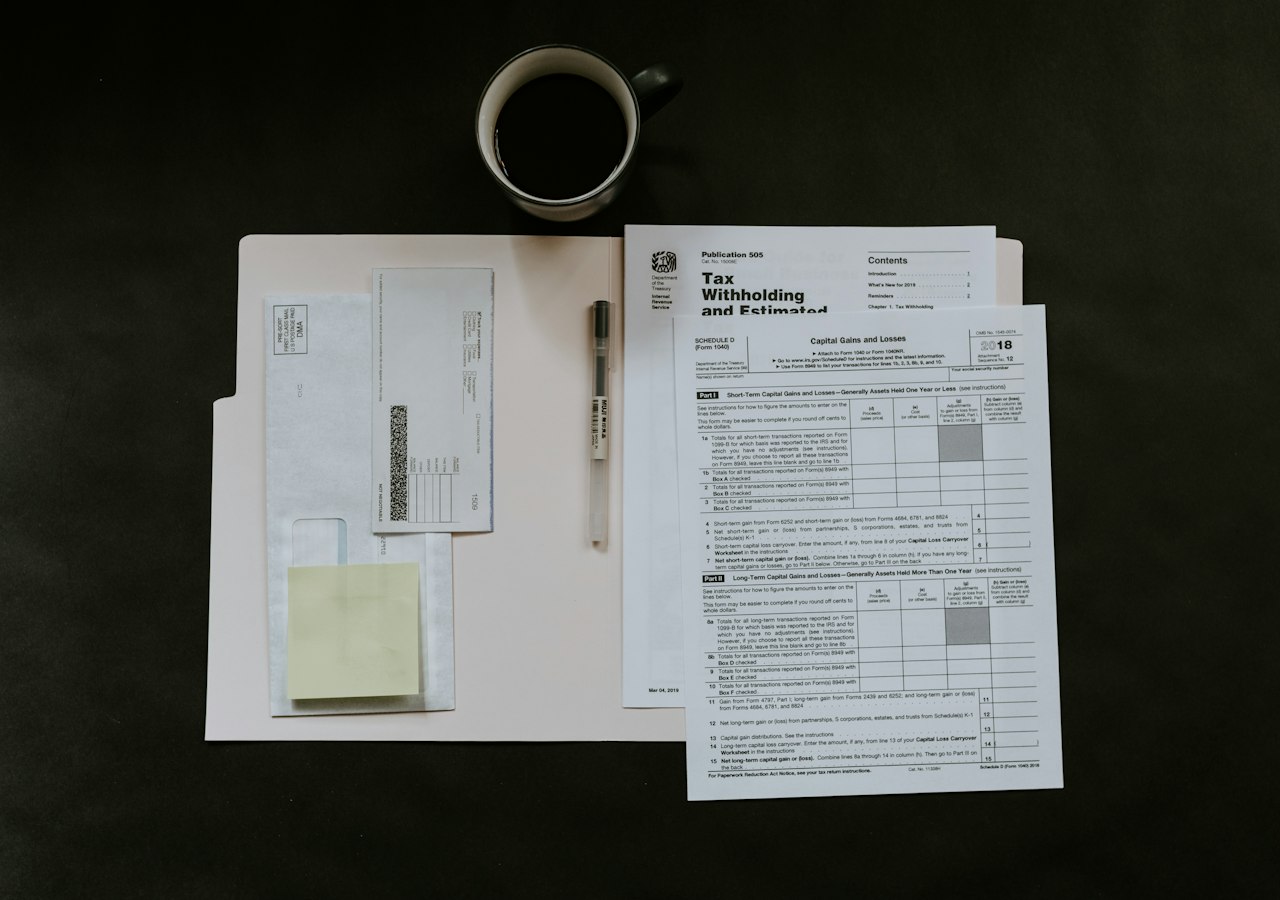 Organized folders and documents on a desk representing Airbnb host record-keeping
