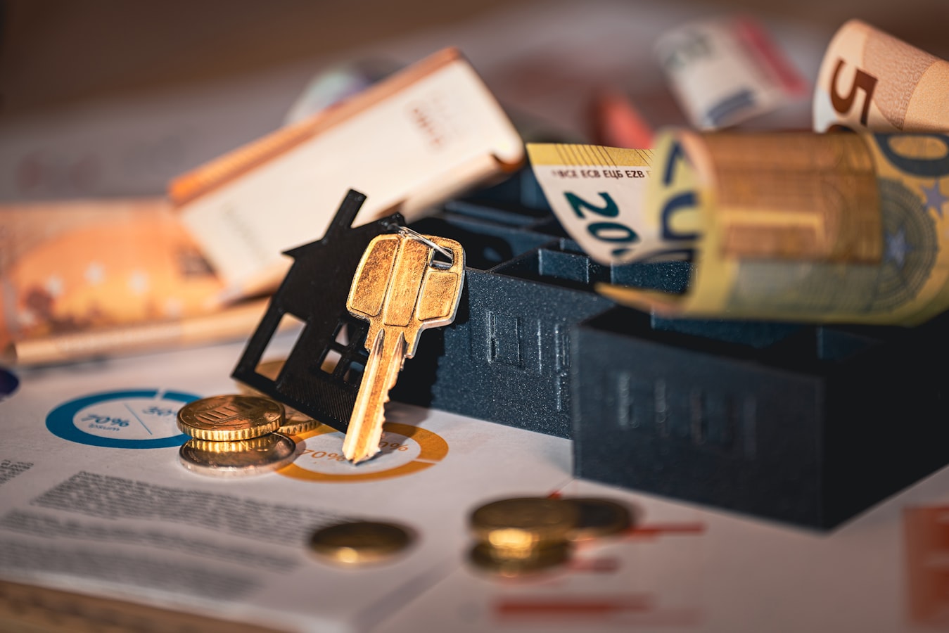 A host reviewing paperwork at a desk beside a set of house keys