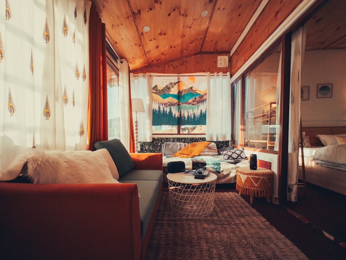 A dog sitting on a furnished living room couch in a vacation rental home