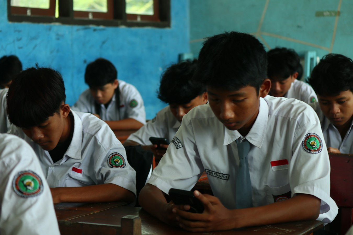 Two college students exchanging contact information on their smartphones