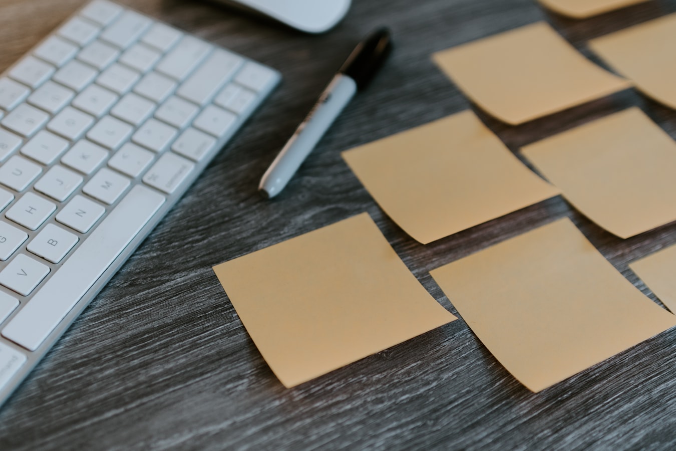 A stack of paper business cards left untouched on a desk after a conference