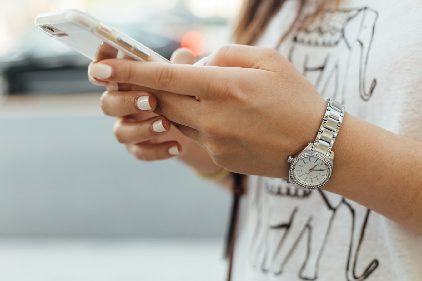 A short-term rental host reviewing guest messages on a smartphone at a desk