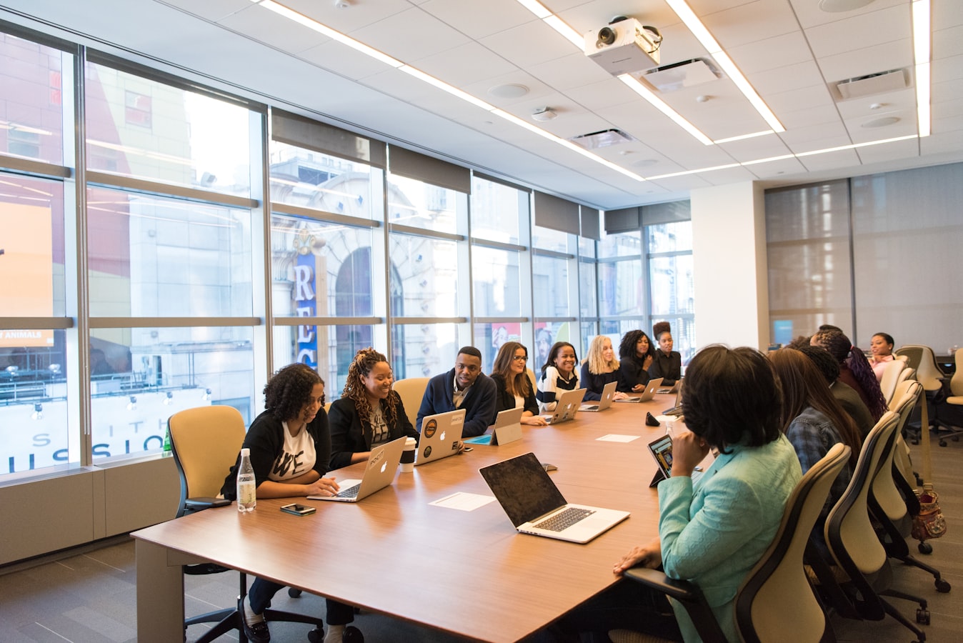 A diverse group of professionals gathered around a table, collaborating during a team meeting