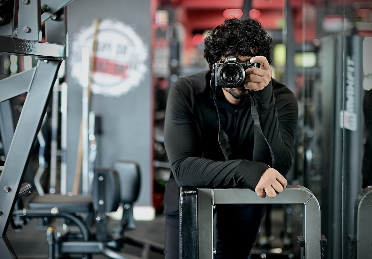 Photographer capturing an athlete lifting weights in a gym