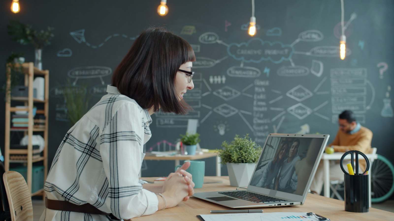 Person on a Zoom video call at a tidy desk, ready to share contact details