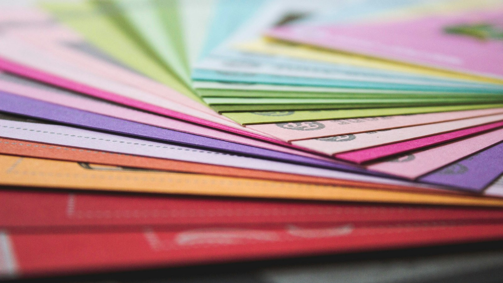 Close-up of layered printed sheets on a press bed showing stacked paper and ink