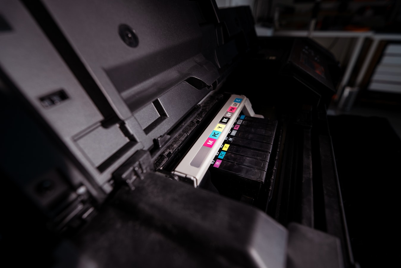 Close-up of CMYK ink swatches laid out on a prepress workbench