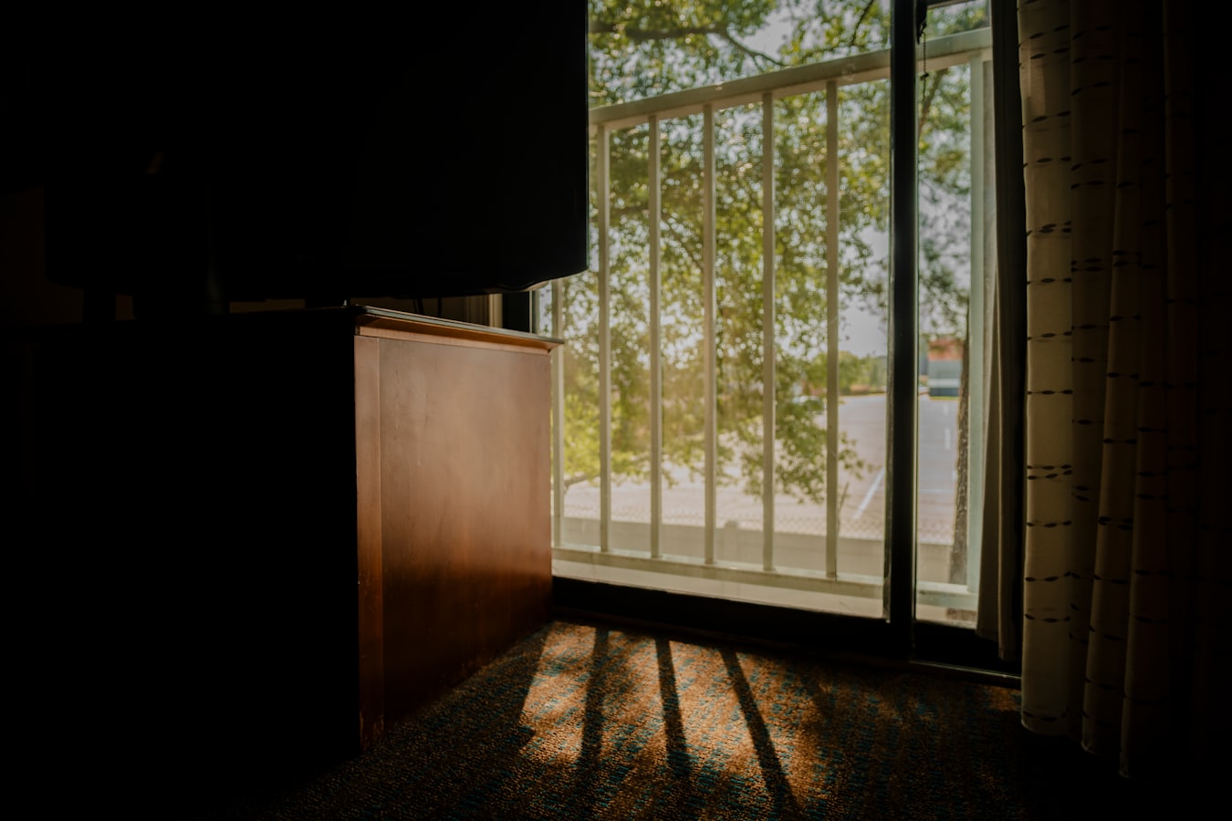 Guest pulling a suitcase toward an open vacation rental front door in the morning