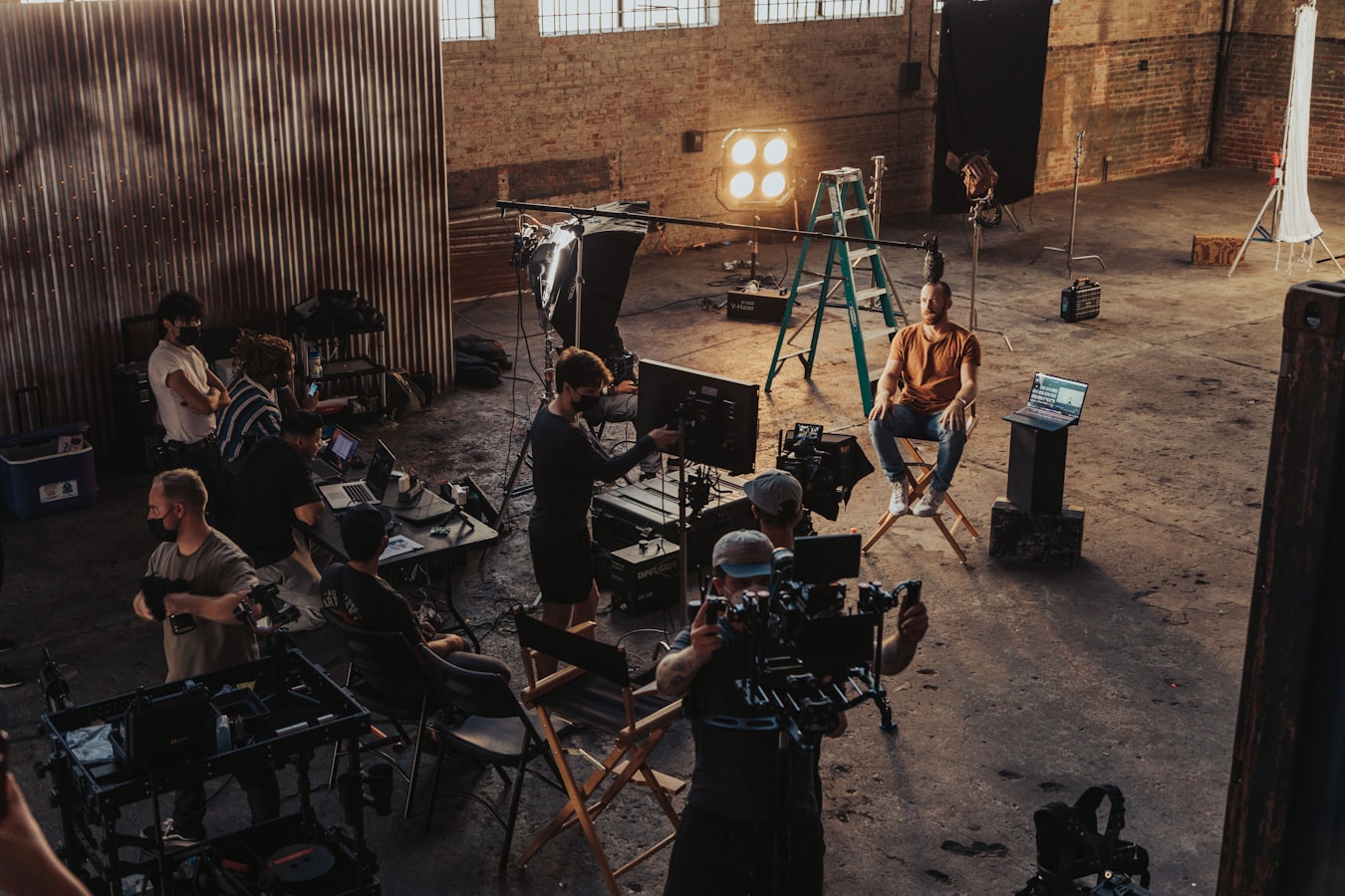Photographer shooting behind the scenes on a busy film set