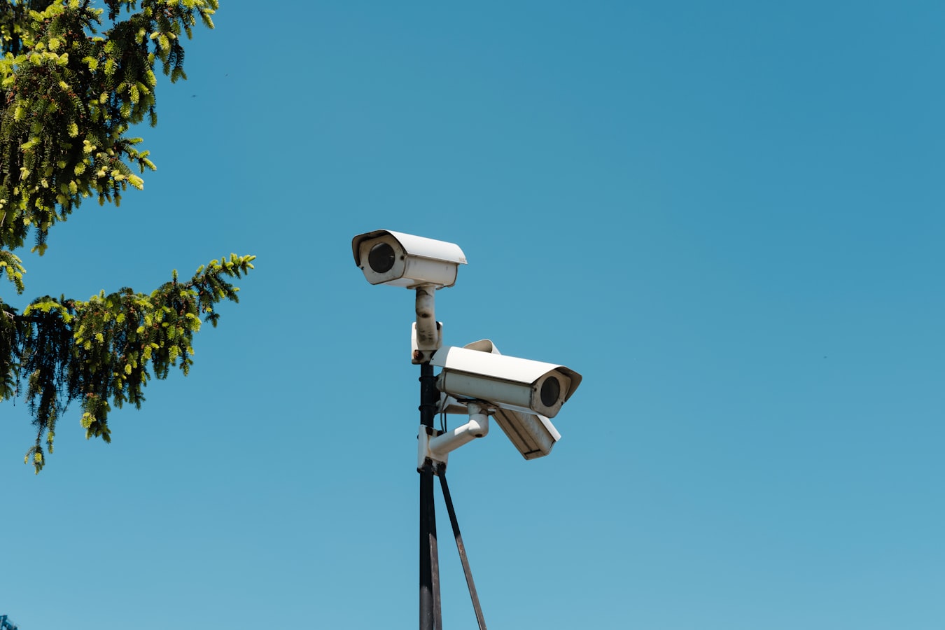 A small security camera mounted near the front door of a vacation rental home