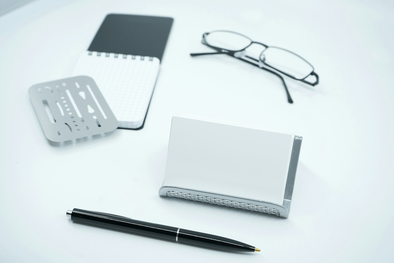 A person reviewing and sorting contact information at a tidy desk after a networking event