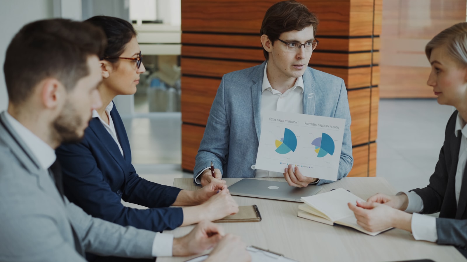 Two sales professionals shaking hands after a meeting