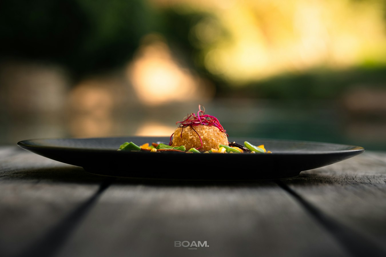 Photographer shooting a styled food spread on a studio table