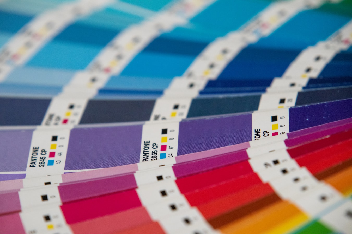 Close-up of CMYK color layers overlapping on a printed sheet