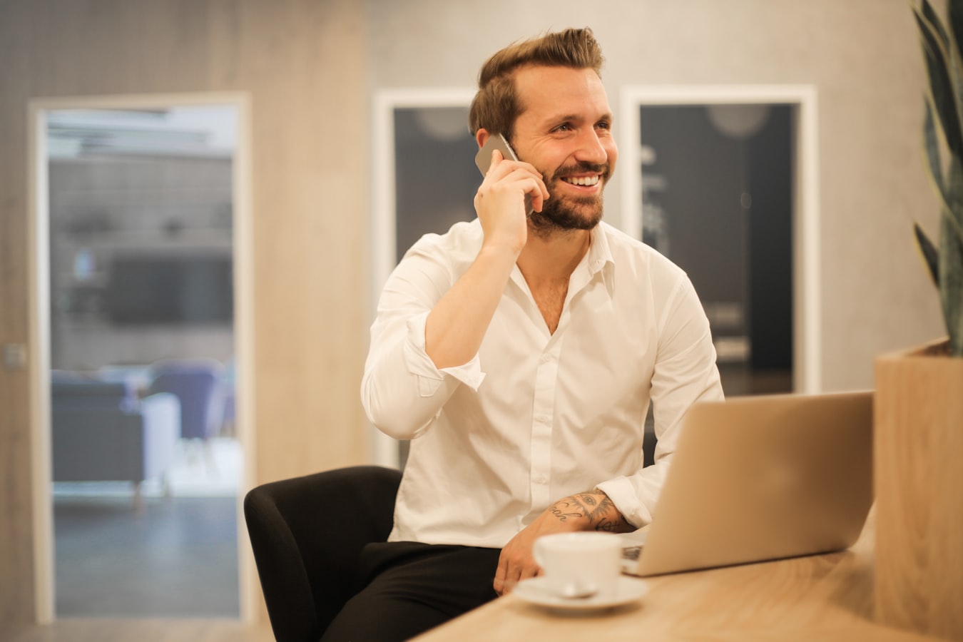 A professional sharing their contact details on a smartphone with a colleague